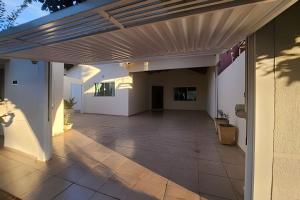 an open patio with awning on a house at Campo Grande Guest Flat in Campo Grande