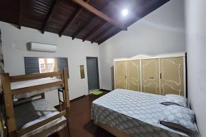 a bedroom with a bed and a ladder in it at Dourados Guest Flat, your choice in Dourados-MS. in Dourados