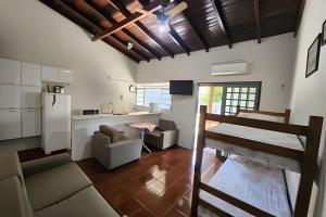 a kitchen and living room with a couch and a table at Dourados Guest Flat, your choice in Dourados-MS. in Dourados