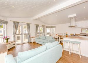 a large living room with a couch and a kitchen at Talacre Beach Resort in Talacre