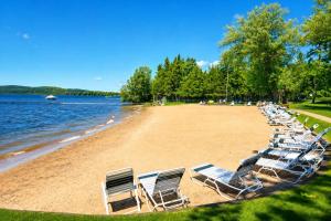 a row of chairs on a beach next to the water at Legends Fountain View Ground Floor Studio Unit 109 in Bellaire
