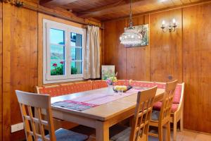 a dining room with a wooden table and chairs at Reesbauernhof - Fewo Abendrot in Oberried +23 photos