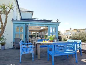 a patio with a table and chairs and a gazebo at Headland Views in Newquay