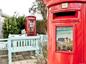 a red post box and a red phone booth at Headland Views in Newquay