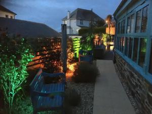 a blue bench sitting in a yard at night at Headland Views in Newquay +43 photos