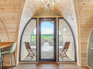 a room with a large glass door with two chairs at The Warren - Uk47582 in Sutton on the Hill