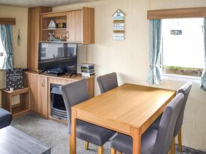 a dining room with a wooden table and chairs at Beech Walk 45 - Ukc9406 in Exmouth