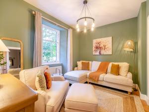 a living room with two couches and a window at West Lodge in Perth