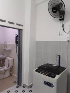 a kitchen with a stove and a toilet and a fan at TBSC by Reemon in Keningau