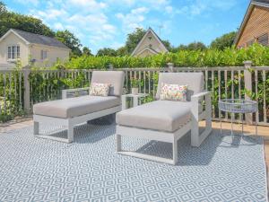 a pair of chairs and a table on a patio at Woodlea Farm in Four Marks +28 photos