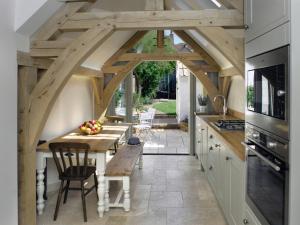 a kitchen with a table with a bench in it at Pemberly in Winchester