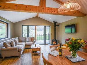 a living room with a couch and a table at Lakeside Lodge - Uk50627 in Welshpool