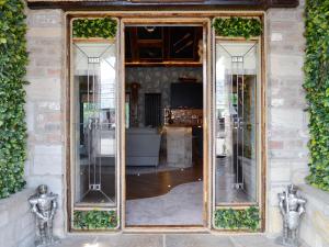 a large mirror on the side of a building at Tennox Boathouse - Ukc4438 in Kilbirnie