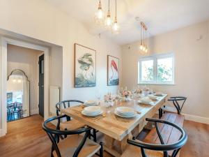 a dining room with a wooden table and chairs at The Old Doctors Manor House in Whitstable