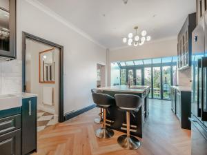 a kitchen with a table and two stools at The Old Doctors Manor House in Whitstable