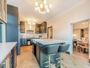 a kitchen with a large island with blue countertops at The Old Doctors Manor House in Whitstable