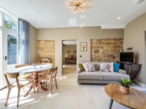 a living room with a couch and a table at Coach House - Uk51830 in Great Ayton