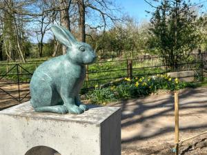 a statue of a rabbit sitting on a concrete block at Coach House - Uk51830 in Great Ayton