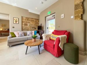 a living room with a couch and a table at Coach House - Uk51830 in Great Ayton +18 photos