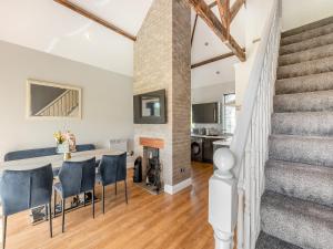 a kitchen and living room with a fireplace and stairs at Vallum Villa - Uk40231 in Bardon Mill +19 photos