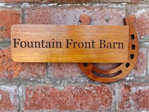 a sign that reads fountain front ban hanging on a brick wall at Fountain Front Barn - Uk45937 in Corley