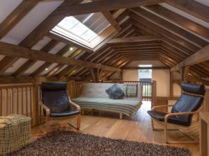 a living room with a couch and two chairs at Coot Lodge in Somerford Keynes