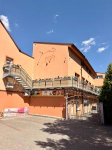 a building with a clock on the side of it at Penzion VV SUN - REOS in Hodonín