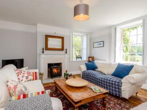 a living room with a couch and a table at Colveston Manor in Cranwich