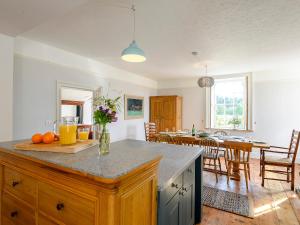 a kitchen with a counter top and a dining room at Colveston Manor in Cranwich