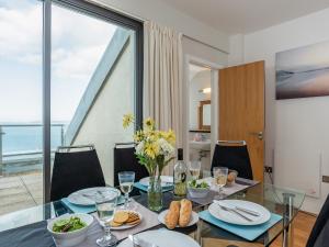 a dining room with a table with food on it at Sand Dunes in Westward Ho