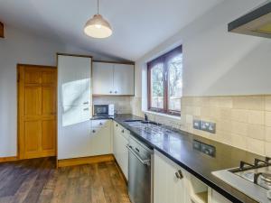 a kitchen with a white refrigerator and a sink at The Lodge - Uk13202 in Cayton