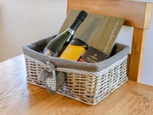 a basket with two bottles of wine and a book at The Lodge - Uk13202 in Cayton +17 photos