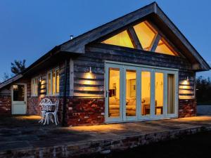 a log cabin with a large glass door at The Cwtch - Os7 in Newtown