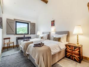 a bedroom with two beds and a window at Loch Farm Stables in Watton +7 photos
