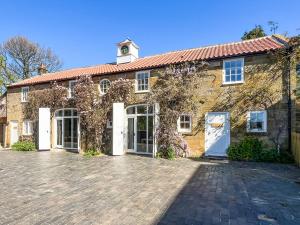 a brick house with a white door and a brick driveway at Stables - Uk51829 in Great Ayton