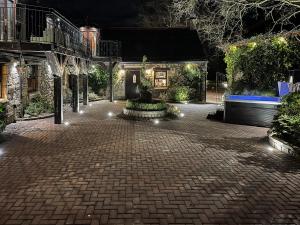 a courtyard at night with lights and a building at Tennox Stables - Uk39975 in Kilbirnie