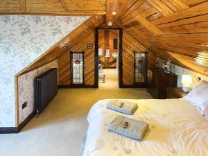 a bedroom with a large bed in a attic at Tennox Stables - Uk39975 in Kilbirnie