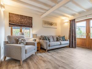 a living room with two chairs and a couch at The Old Farmhouse in Longford