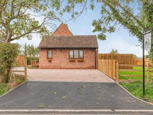 an empty driveway in front of a brick house at The Old Farmhouse in Longford