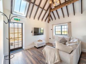 a living room with a couch and a tv at Corley Rocks Barn - Uk45939 in Corley +10 photos