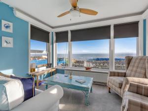 a living room with a couch and a table at Roggle Roich in Hilton of Cadboll