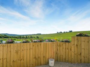 a wooden fence with flowers in a yard at Trig View - Uk49915 in Bardon Mill