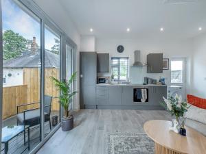a living room with a table and a kitchen at Trig View - Uk49915 in Bardon Mill +5 photos