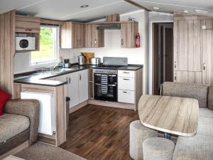 a kitchen and living room with a table and chairs at Elms 116 - Ukc9403 in Exmouth