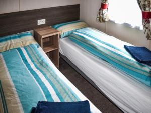 two beds sitting next to each other in a room at Elms 116 - Ukc9403 in Exmouth
