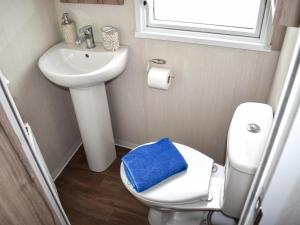 a small bathroom with a toilet and a sink at Elms 116 - Ukc9403 in Exmouth +4 photos