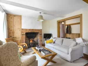 a living room with a couch and a fireplace at The Haven in Ludlow