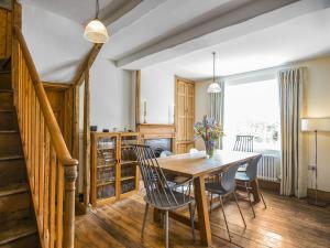 a dining room with a wooden table and chairs at The Haven in Ludlow