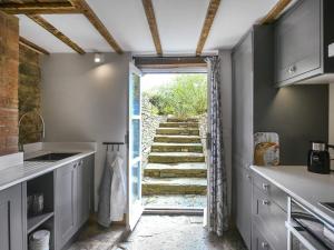 a kitchen with a door leading to a stairway at The Haven in Ludlow +12 photos