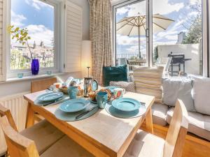 a dining room with a table with blue dishes on it at Dolphins Reach in Saint Mawes